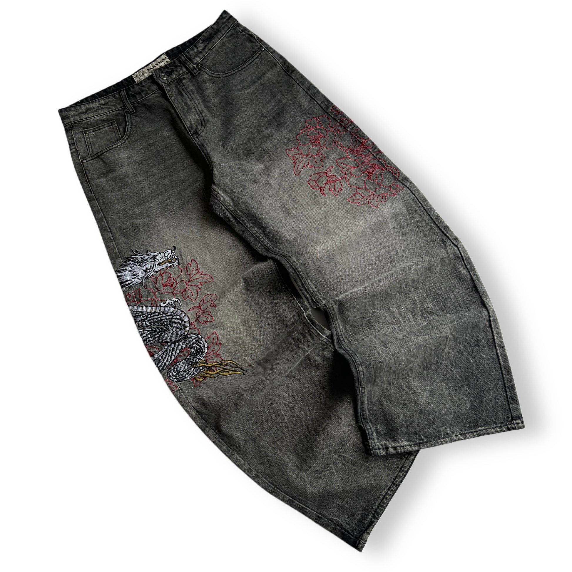 Black jeans with red and white embroidery on a white background