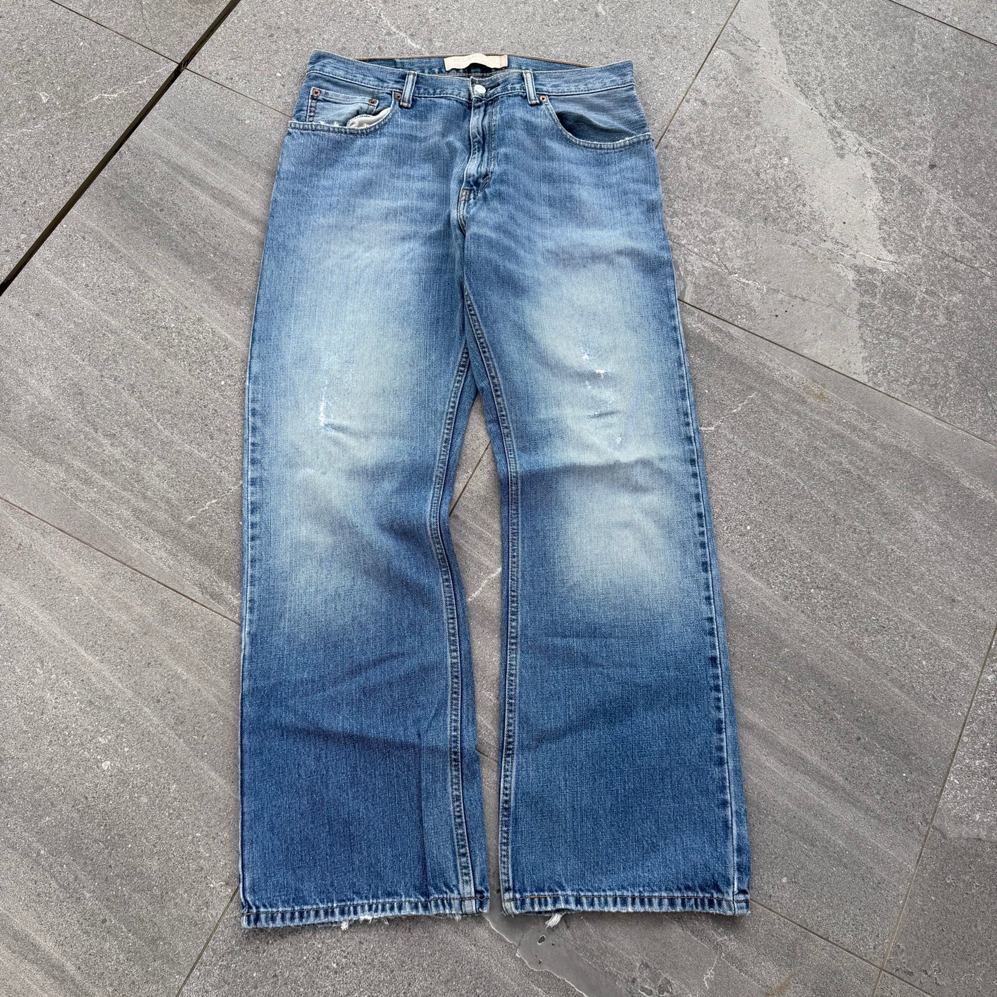 unreal fade. levi’s 557 relaxed bootcuts - 34x32”