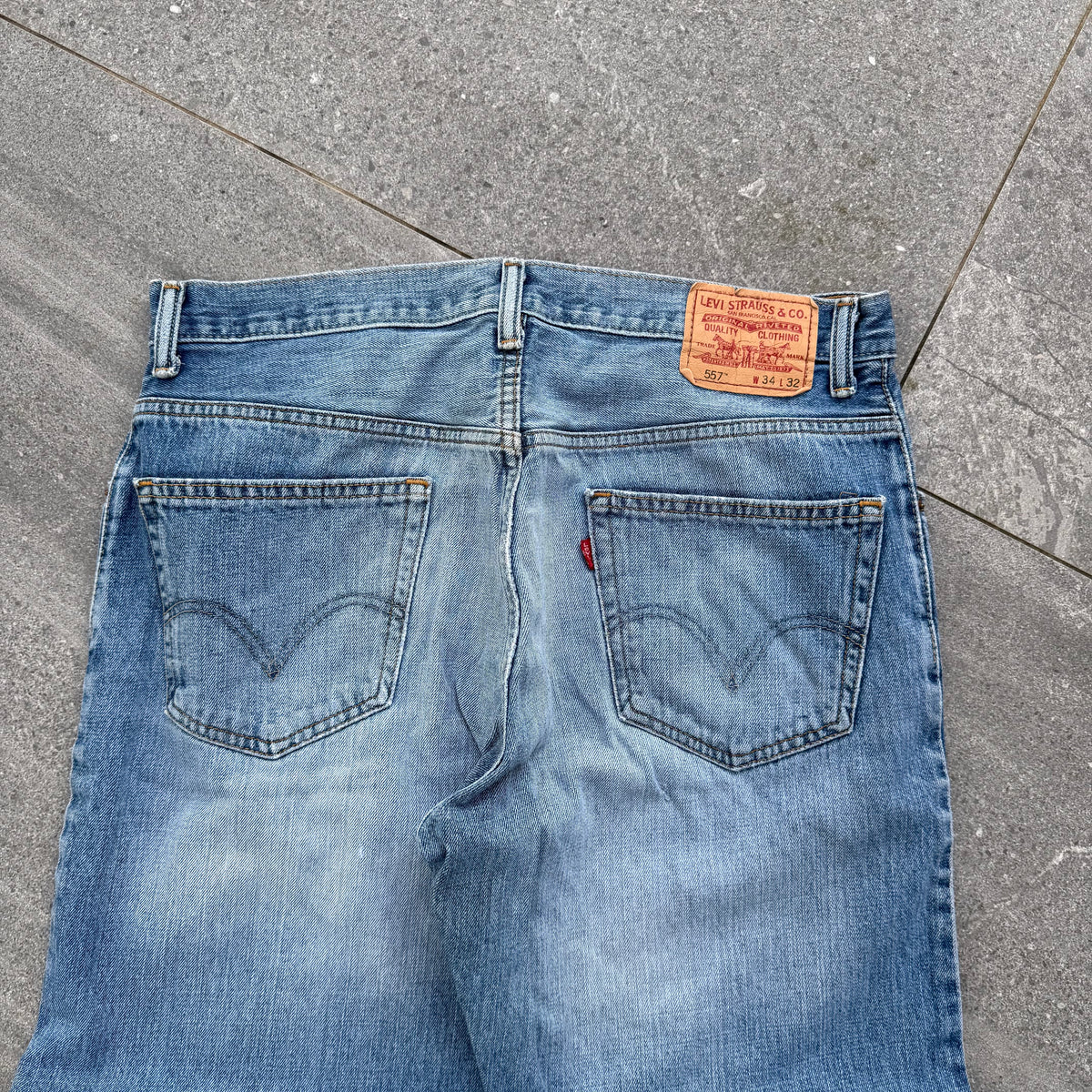 unreal fade. levi’s 557 relaxed bootcuts - 34x32”